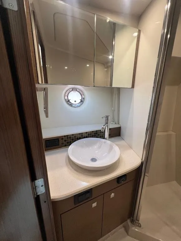 Slide: The Image of 2014 Cruisers Yachts 45 Cantius Black Diamond bathroom with modern sink and mirror. - 48