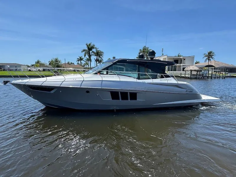 Slide: The Image of 2014 Cruisers Yachts 45 Cantius Black Diamond on water, with palm trees in background. - 5