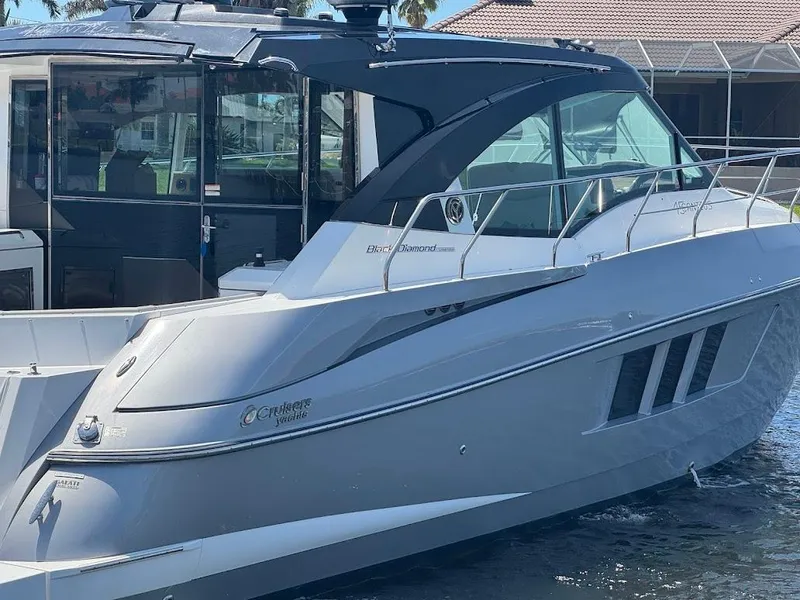 Slide: The Image of 2014 Cruisers Yachts 45 Cantius Black Diamond, sleek design, docked in marina. - 9