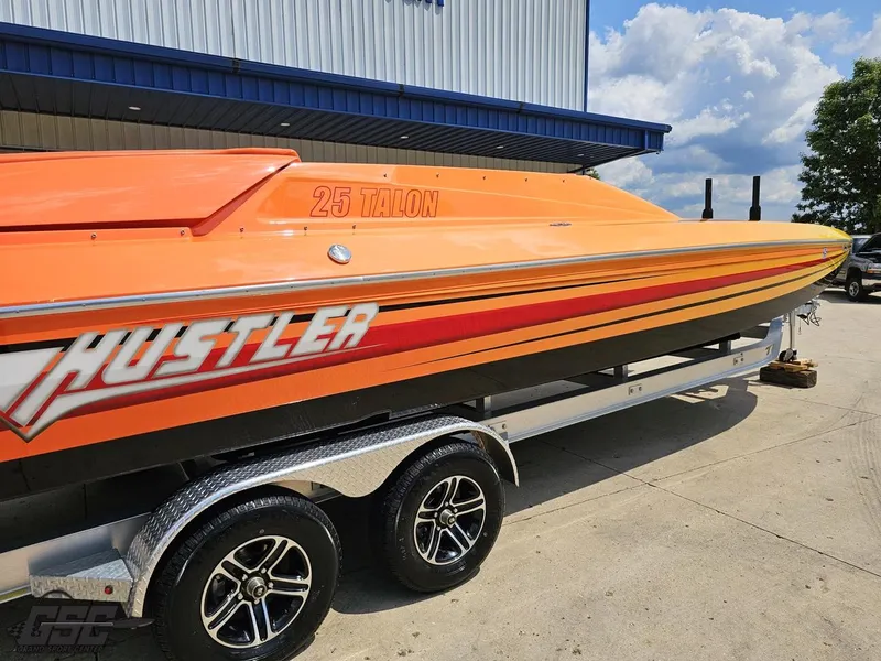 Slide: The Image of 2019 Hustler 25 Talon Cat boat in vibrant orange on a trailer. - 11