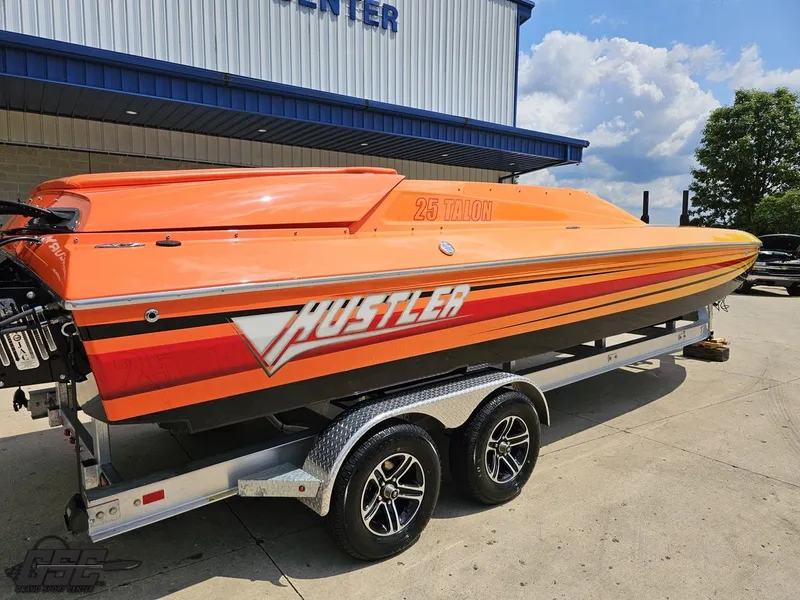 Slide: The Image of 2019 Hustler 25 Talon Cat boat in vibrant orange on a trailer. - 12