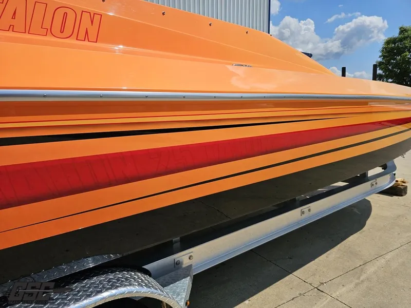 Slide: The Image of 2019 Hustler 25 Talon Cat boat in vibrant orange on a trailer. - 14