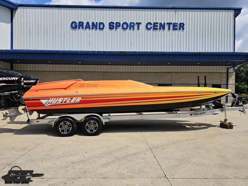 Slide: The Image of 2019 Hustler 25 Talon Cat boat at Grand Sport Center, vibrant orange and yellow design. - 2