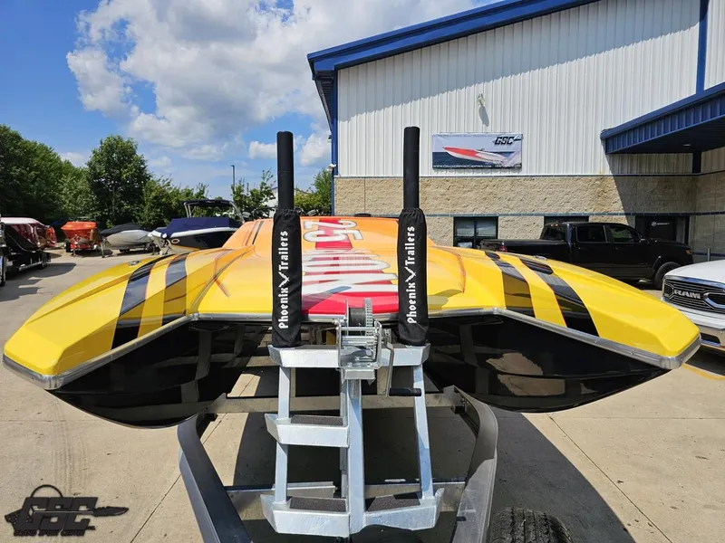 Slide: The Image of 2019 Hustler 25 Talon Cat boat on trailer, vibrant yellow and black design, outdoor setting. - 20