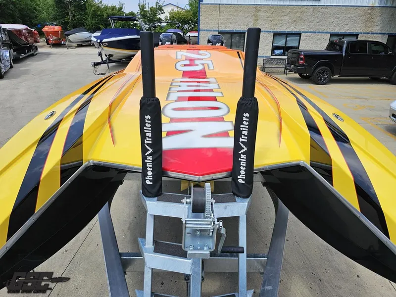 Slide: The Image of 2019 Hustler 25 Talon Cat boat on trailer, vibrant yellow and black design. - 21
