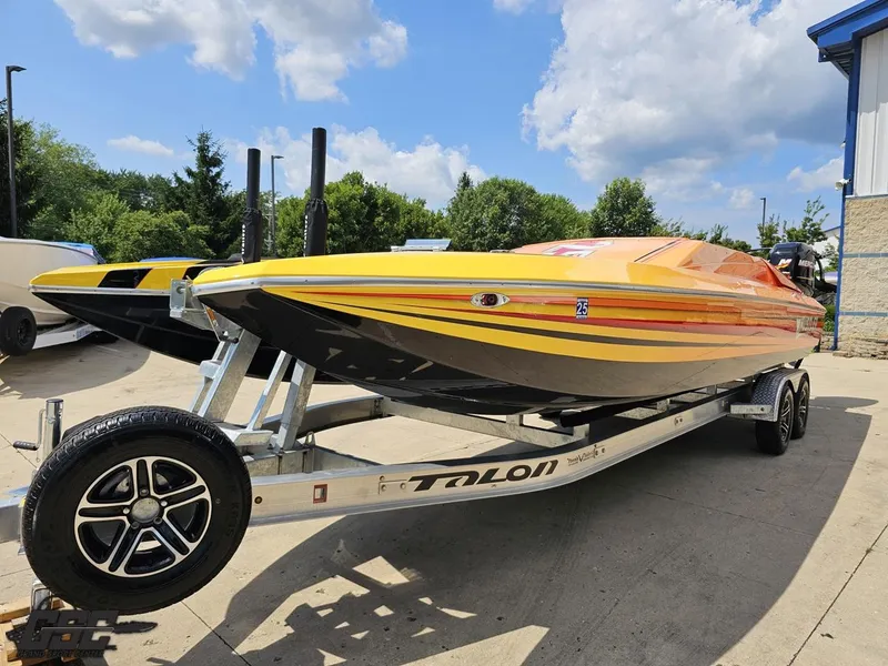 Slide: The Image of 2019 Hustler 25 Talon Cat speedboat on trailer, vibrant yellow and orange design. - 24