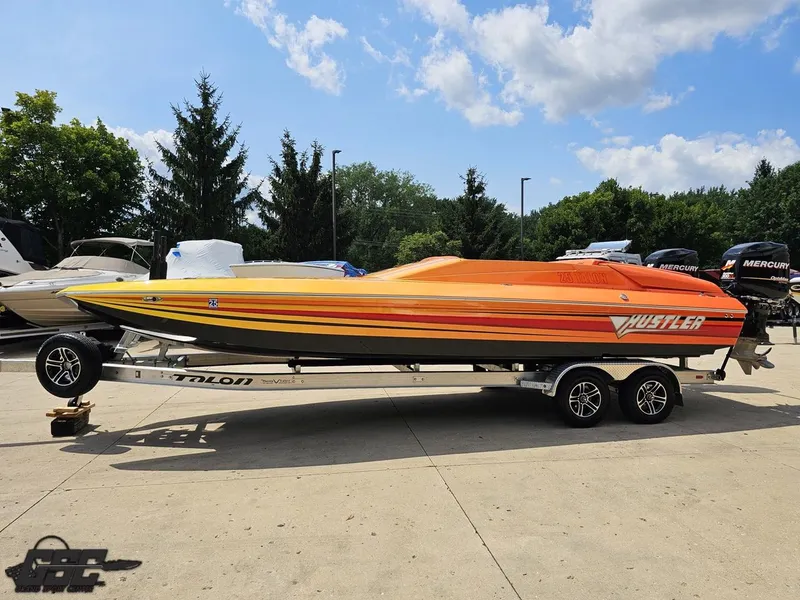 Slide: The Image of 2019 Hustler 25 Talon Cat boat on trailer, vibrant orange and yellow design. - 27
