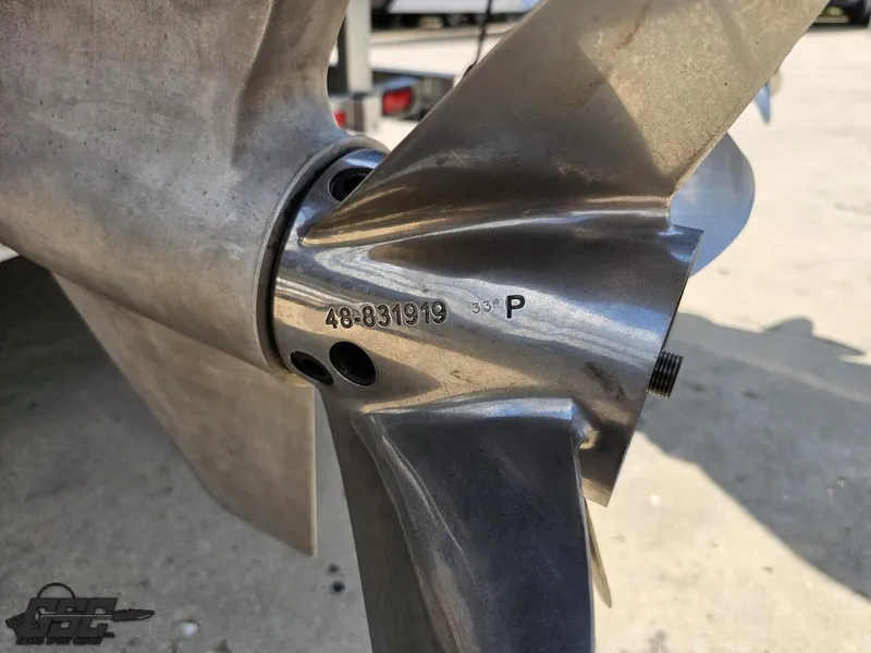 Slide: The Image of Close-up of a 2019 Hustler 25 Talon Cat boat propeller with engraved serial number. - 49