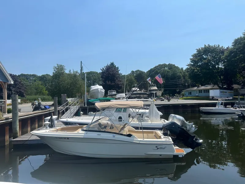Slide: The Image of 2020 Scout 215 Dorado boat docked at a marina on a sunny day. - 1