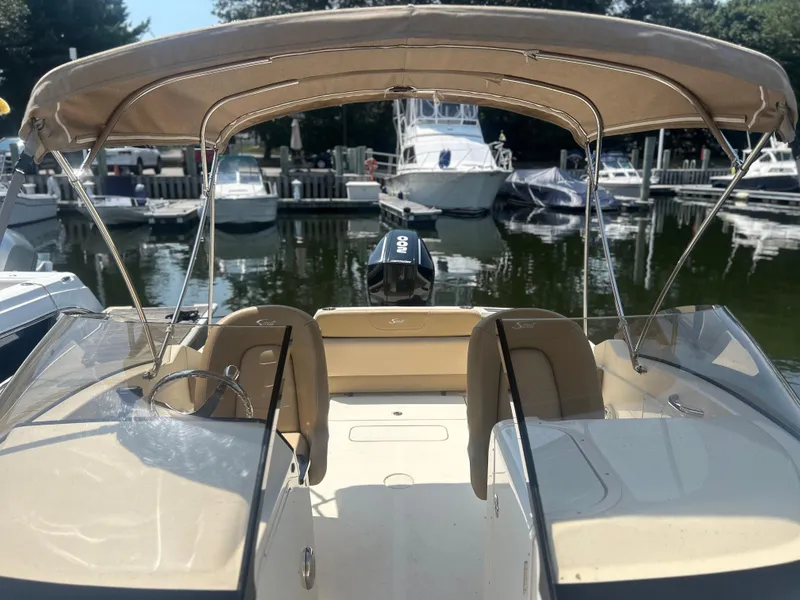 Slide: The Image of 2020 Scout 215 Dorado boat docked at marina with canopy and seating. - 3
