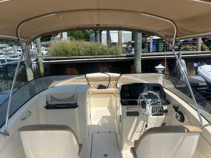 Slide: The Image of 2020 Scout 215 Dorado boat interior with steering wheel and dashboard at marina. - 5