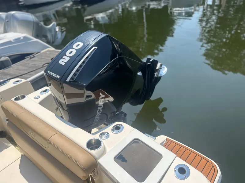 Slide: The Image of 2020 Scout 215 Dorado with Mercury 200 outboard engine, docked on calm water. - 6