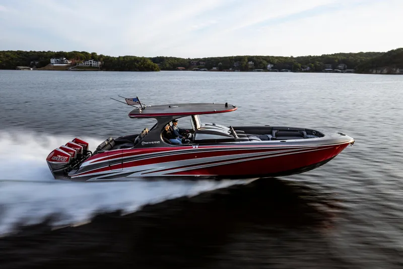 The Image of 2025 Mystic Powerboats M4200 speeding on a lake, showcasing sleek design and powerful engines. - 1