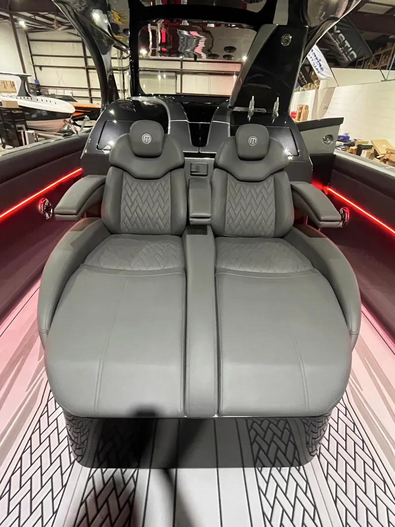 Slide: The Image of Luxurious interior seating of 2025 Mystic Powerboats M4200 with sleek design and ambient lighting. - 5