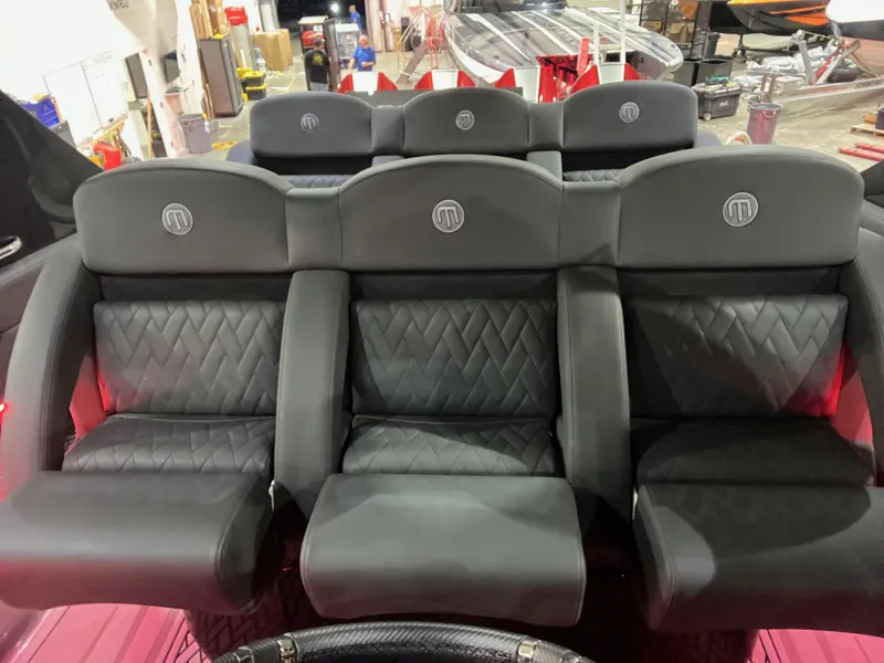 Slide: The Image of Luxurious seating in 2025 Mystic Powerboats M4200, featuring sleek black leather upholstery. - 8