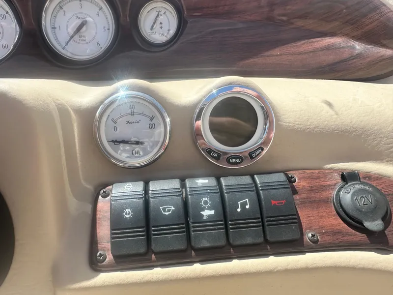 Slide: The Image of Dashboard of a 2008 Glastron 205 GX boat with gauges and control switches. - 10