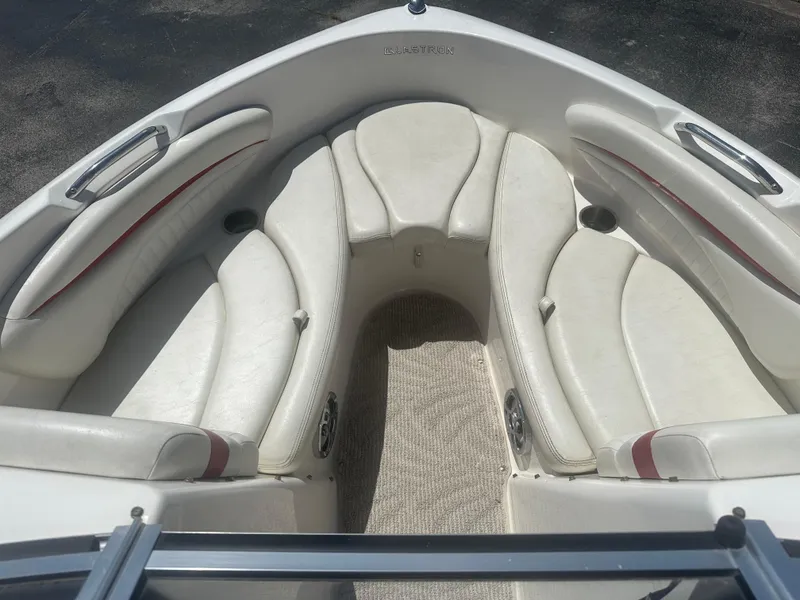 Slide: The Image of 2008 Glastron 205 GX boat interior with white cushioned seating and carpeted floor. - 12