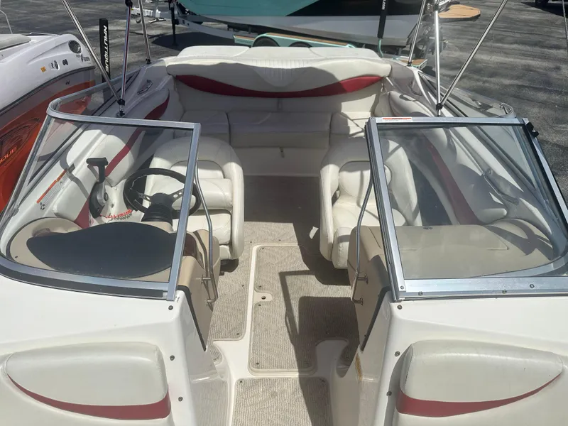 Slide: The Image of 2008 Glastron 205 GX boat interior with white and red seating, steering wheel, and open windshield. - 13