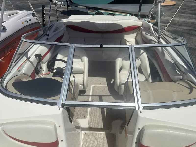 Slide: The Image of 2008 Glastron 205 GX boat interior with white and red seating, steering wheel, and windshield. - 14