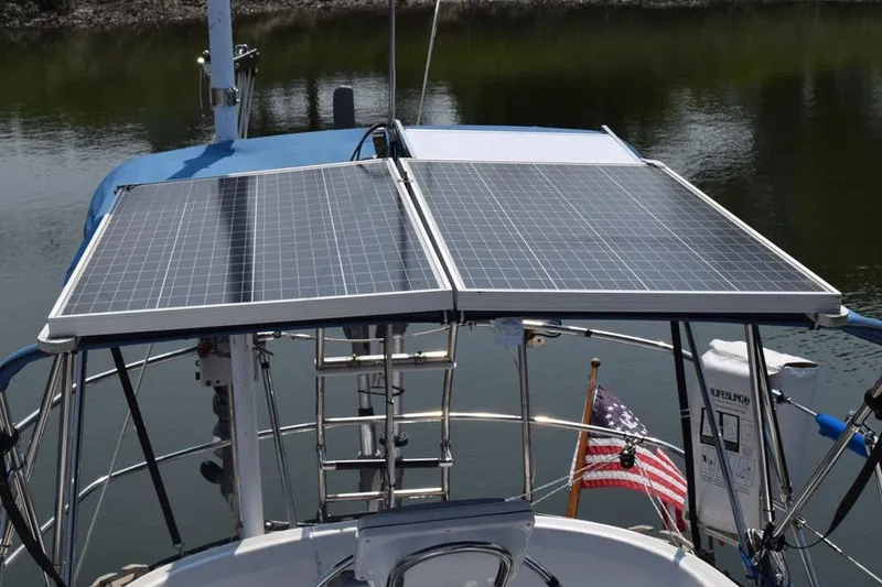 Slide: The Image of Solar panels on a 1981 C&C 37 sailboat, with an American flag in the background. - 13