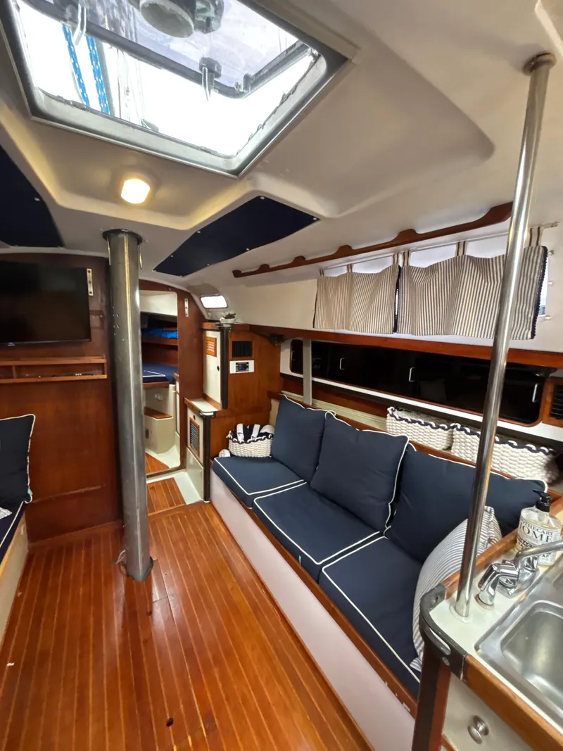Slide: The Image of Interior of 1981 C&C 37 sailboat with cozy seating and wooden flooring. - 21