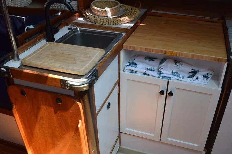 Slide: The Image of Compact kitchen area in a 1981 C&C 37 sailboat with sink and storage cabinets. - 36