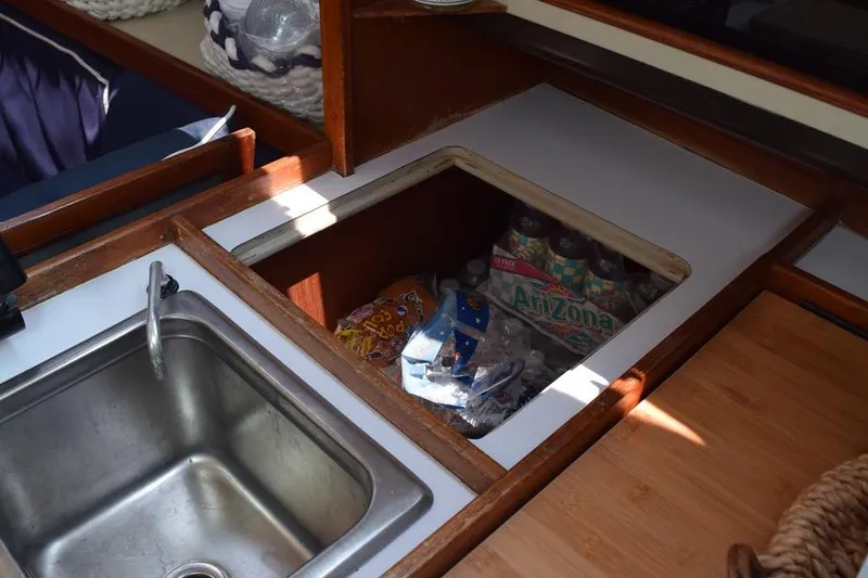 Slide: The Image of 1981 C&C 37 yacht galley with sink and storage compartment. - 38