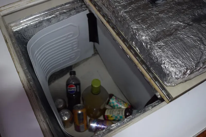 Slide: The Image of Cooler compartment in 1981 C&C 37 yacht with drinks and insulation. - 44