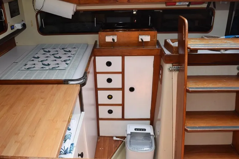 Slide: The Image of Interior of 1981 C&C 37 sailboat with wooden cabinetry and compact kitchen area. - 46
