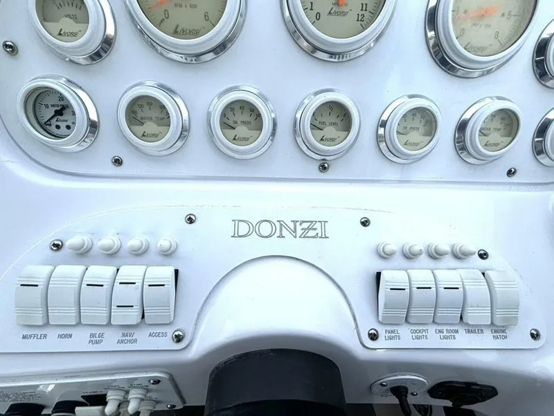 Slide: The Image of Dashboard of a 2005 Donzi 33ZX boat with gauges and switches. - 25