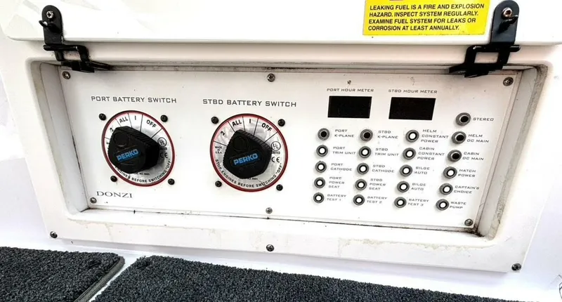 Slide: The Image of Control panel of a 2005 Donzi 33ZX boat with battery switches and hour meters. - 44