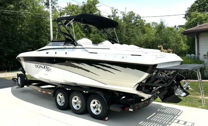 Slide: The Image of 2005 Donzi 33ZX powerboat on trailer, sleek design, parked outdoors. - 3