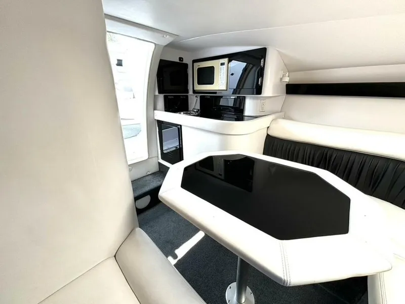 Slide: The Image of Interior of 2005 Donzi 33ZX boat with modern seating, table, and kitchenette. - 34