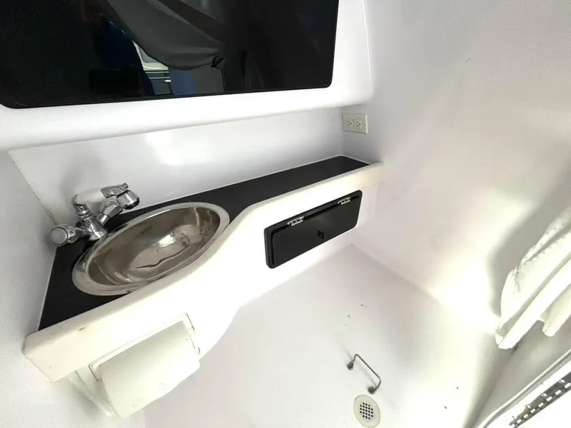 Slide: The Image of Interior of a 2005 Donzi 33ZX boat featuring a compact sink and countertop. - 37