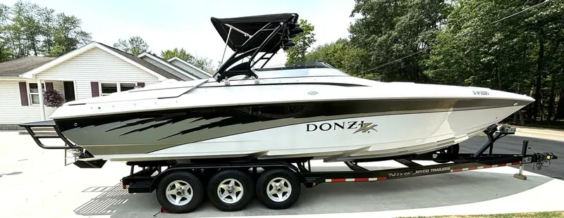 Slide: The Image of 2005 Donzi 33ZX speedboat on trailer, parked in residential driveway. - 6