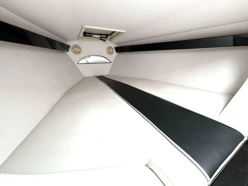 Slide: The Image of Interior cabin of a 2005 Donzi 33ZX boat, featuring sleek white and black upholstery. - 32