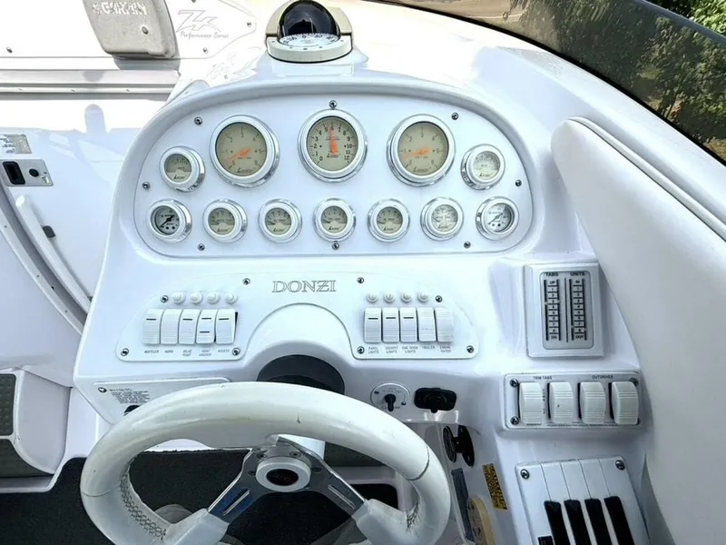 Slide: The Image of Dashboard of a 2005 Donzi 33ZX boat with gauges and controls. - 24