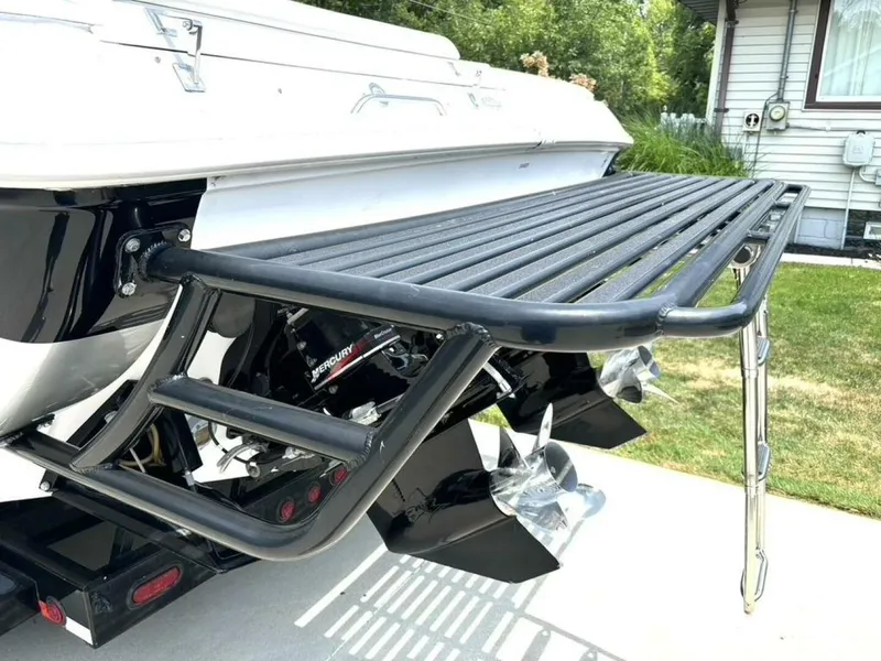 Slide: The Image of 2005 Donzi 33ZX boat with Mercury engine and swim platform, parked outdoors. - 13