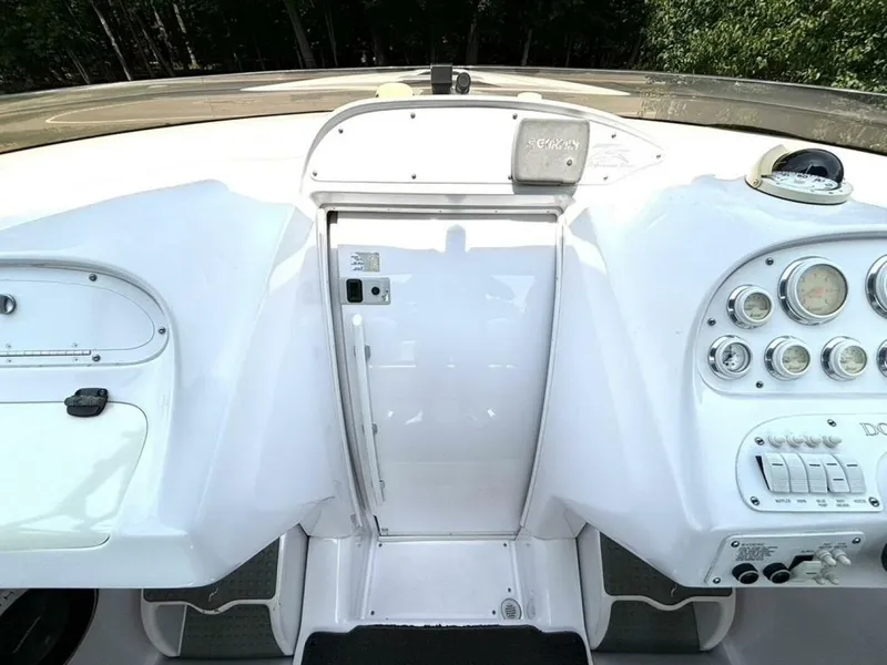 Slide: The Image of 2005 Donzi 33ZX boat dashboard with gauges and controls, featuring a sleek white design. - 28