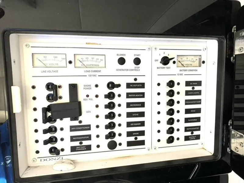 Slide: The Image of Electrical control panel of a 2005 Donzi 33ZX boat, featuring various switches and gauges. - 45