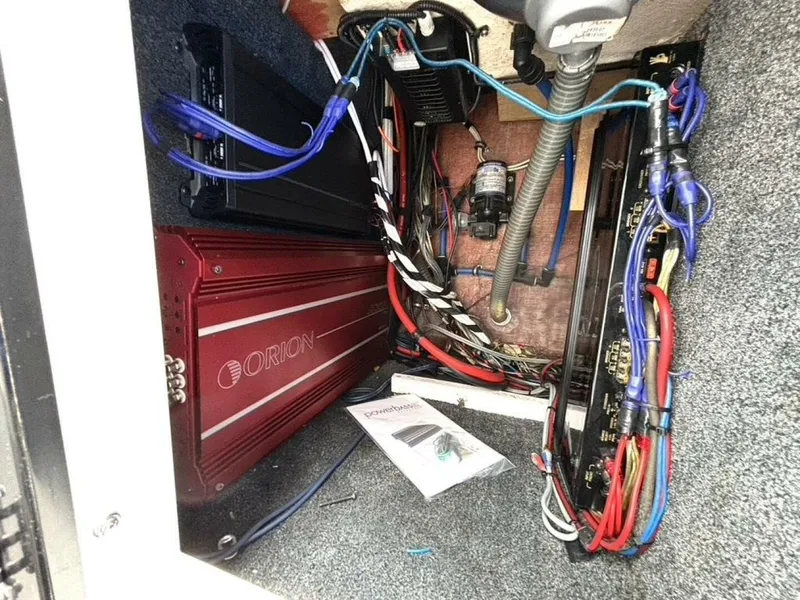 Slide: The Image of Electrical wiring and components inside a 2005 Donzi 33ZX boat, featuring Orion amplifier. - 40