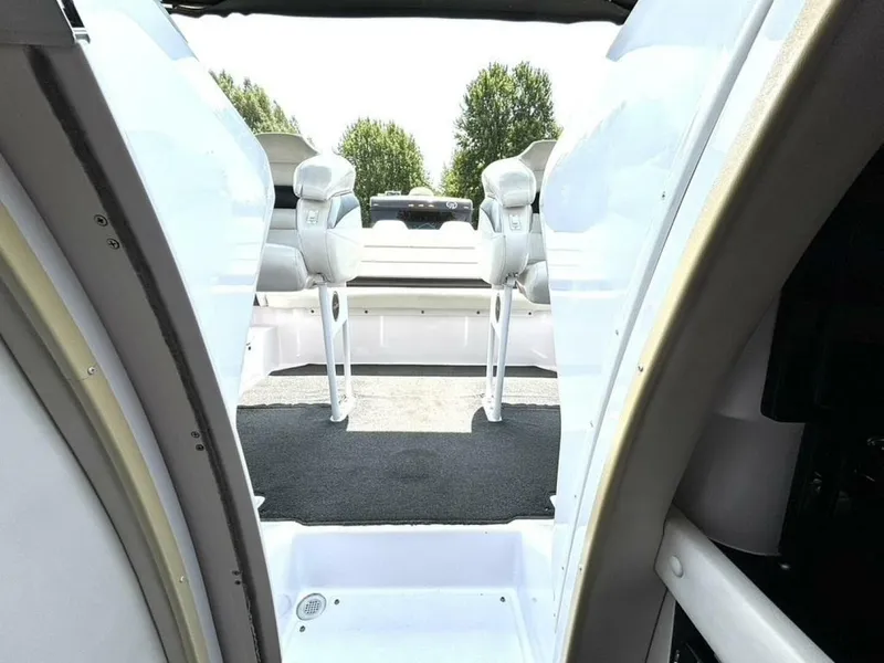 Slide: The Image of 2005 Donzi 33ZX boat interior with white seating and open deck view. - 38
