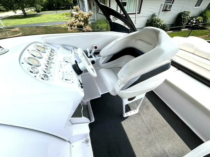 Slide: The Image of 2005 Donzi 33ZX boat cockpit with white seating and detailed control panel. - 22