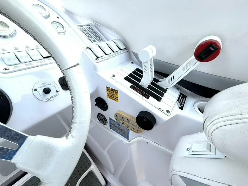 Slide: The Image of 2005 Donzi 33ZX boat cockpit with steering wheel and throttle controls. - 26