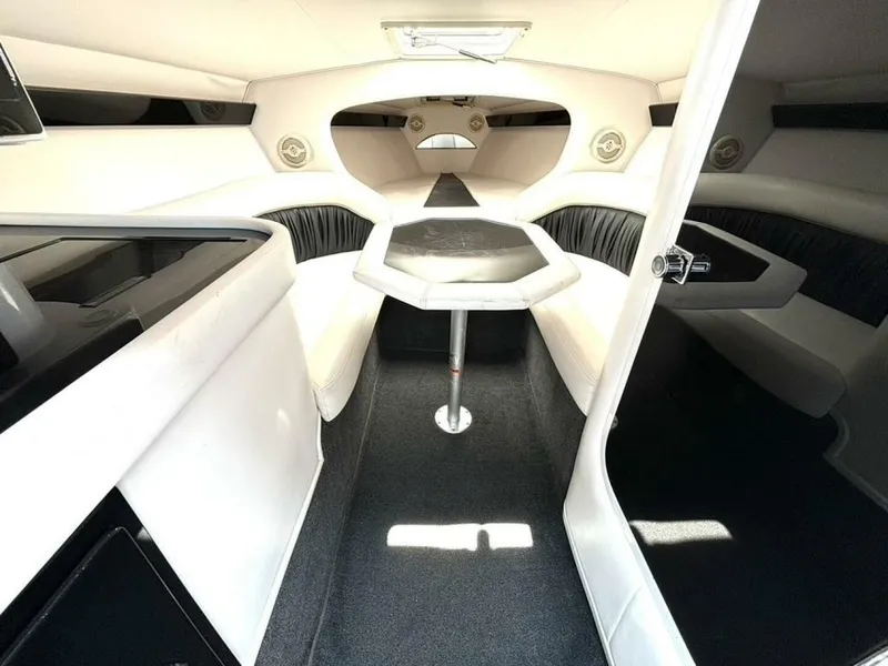 Slide: The Image of Interior of a 2005 Donzi 33ZX boat, featuring white seating and a central table. - 30