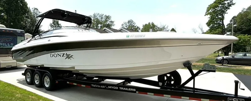 Slide: The Image of 2005 Donzi 33ZX speedboat on a trailer, parked outdoors. - 7