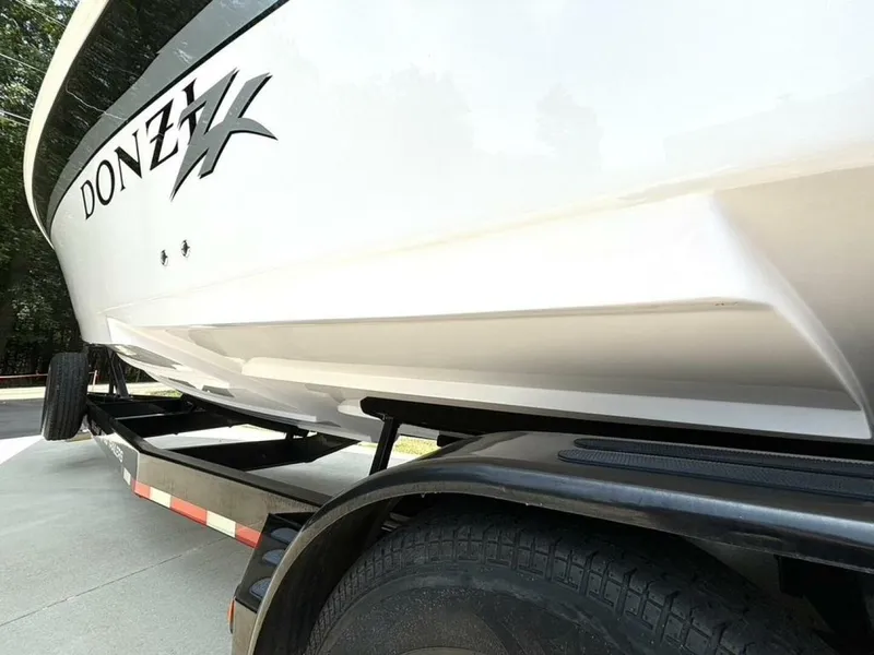 Slide: The Image of 2005 Donzi 33ZX boat on trailer, side view showing sleek hull design. - 9