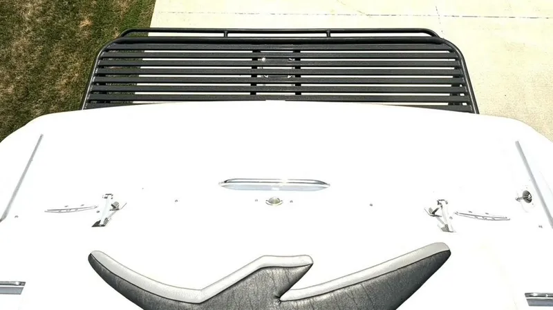 Slide: The Image of 2005 Donzi 33ZX boat deck with black railing and white surface. - 14