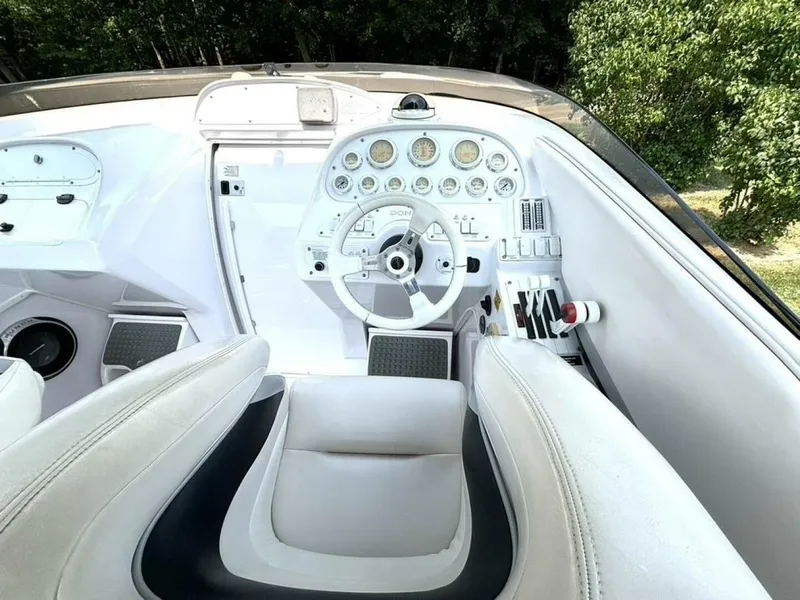 Slide: The Image of 2005 Donzi 33ZX boat cockpit with white steering wheel and control panel. - 23