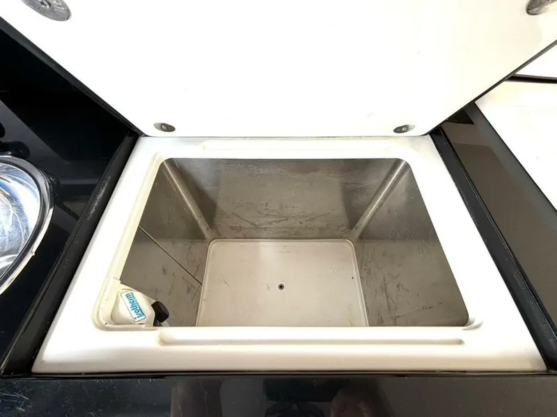 Slide: The Image of Open storage compartment on a 2005 Donzi 33ZX boat, featuring a clean interior. - 36
